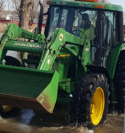 tractor in midwest floodwaters 