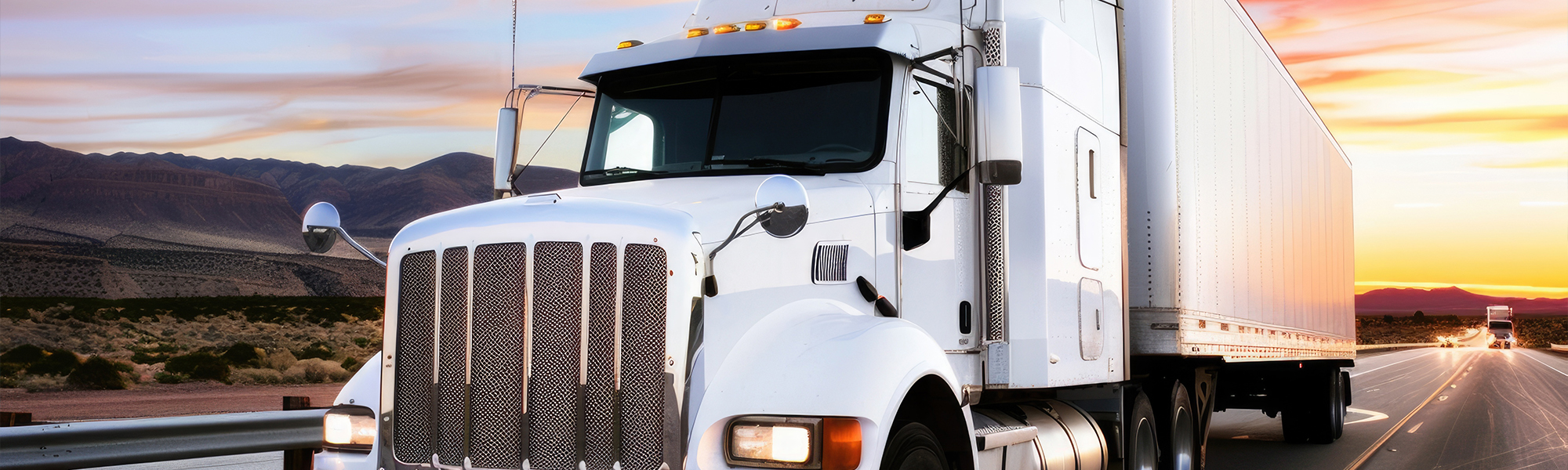 A photo of a white semi truck on the highway